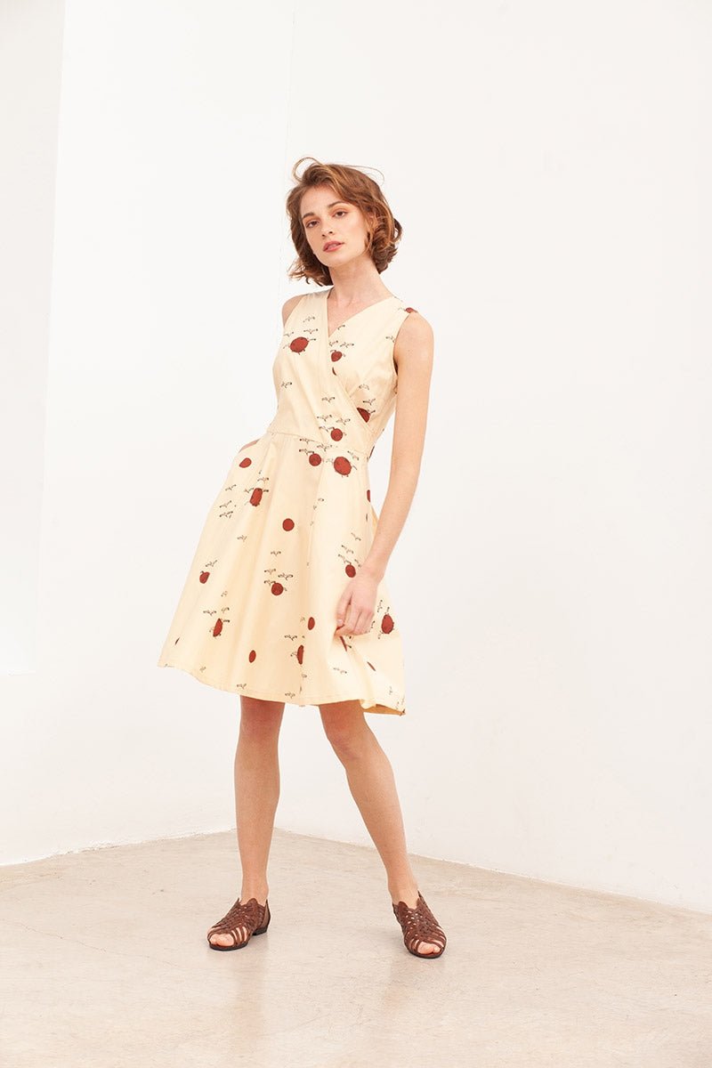 BEGA is a poplin belted wrap dress in beige.