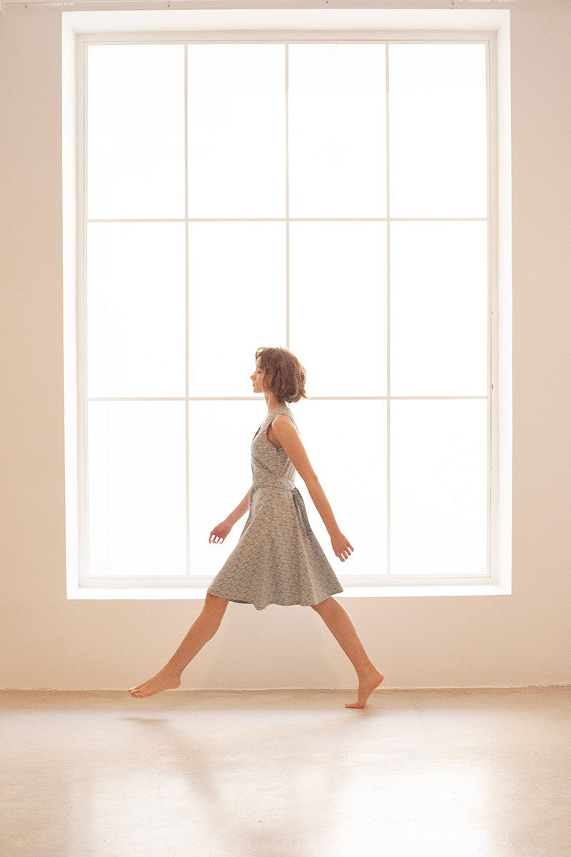 BEGA is a poplin belted wrap dress in blue