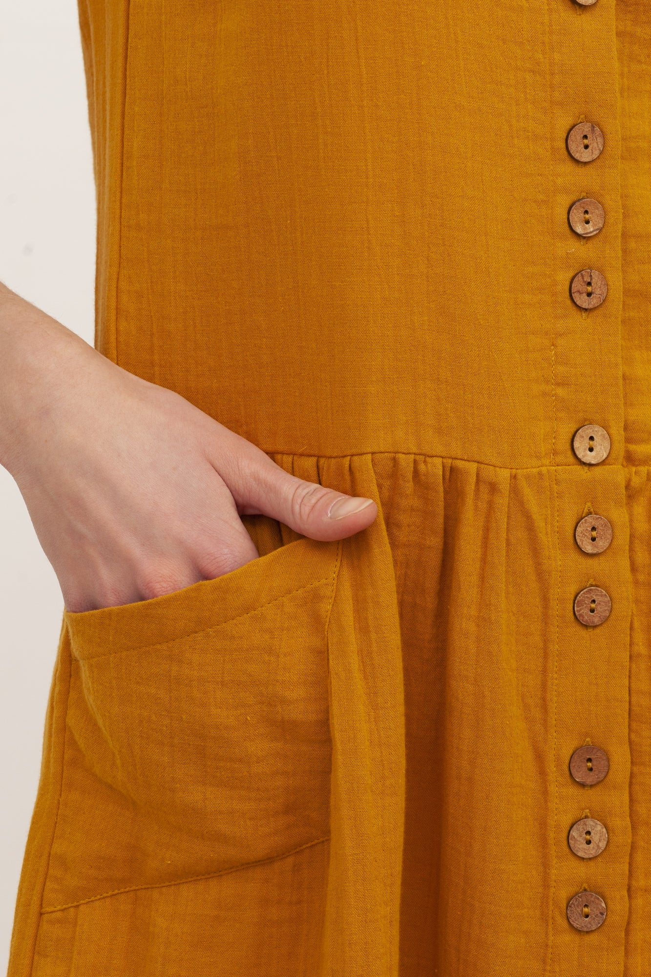 BRUNELLA's V-neck muslin dress in mustard.